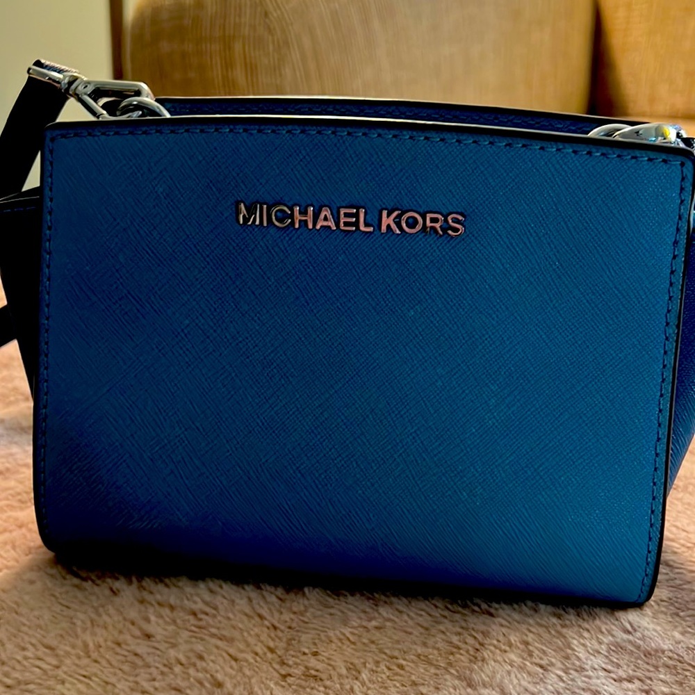Michael Kors shades of blue zipper with long leather strap.